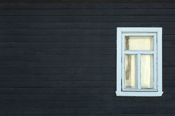 Scandinavian house. Dark wooden wall of the facade of a scandinavian house with a window. Copy space