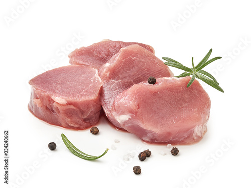 Cuadros en Lienzo Fresh raw pork chop slices with pepper and rosemary isolated on white background