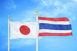 © Aleks Taurus - Japan and Thailand two flags on flagpoles and blue cloudy sky