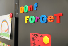 Phrase DON'T FORGET Made Of Magnets On Refrigerator Door, Closeup