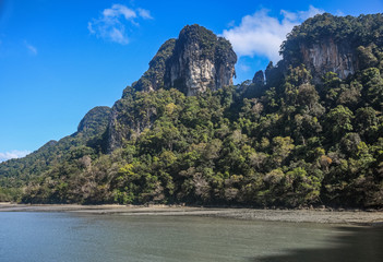 Island Hopping in Langkawi. Familly vacation and tours in Malaysia. Scenic views of small green rocky islands from the boat on Andaman Sea.