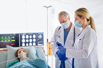 Doctors and infected patient in quarantine in hospital, coronavirus concept.