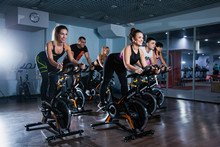 Cycling Class In Fitness Club, Group Of Fit People Spinning On Cardio Machine