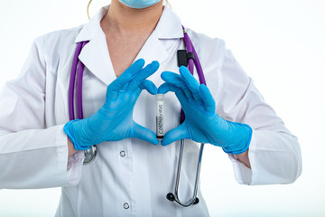 A nurse s hand in a glove holds a test tube with the inscription COVID 19, with a positive blood test for a new rapidly spreading coronavirus, close-up, shallow depth of field, selective focus.