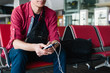 © o_lypa - Traveler with electronic devices at airport terminal