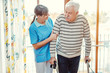 © Kzenon - Nurse helping senior man with walking frame in nursing home