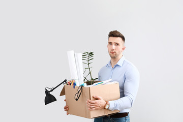 Wall Mural - Sad fired man on light background