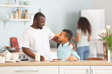 Sticker - African-American man and his son drinking milk in kitchen