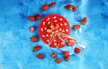 Wall Mural - Delicious strawberry cheesecake with berries on blue rustic background