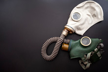 Codependent Relationship, Negative Emotions, Hazardous Affair And Toxic Love Concept With Two Gas Masks Connected On The Same Hose To Represent Codependency Isolated On Dark Background With Copy Space