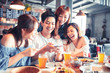 © Tom Wang - happy young people sitting in  restaurant and taking  photo for foods