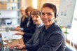 © Krakenimages.com - Group of call center workers working together with smile on face using headset. Young handsome man smiling at the office.