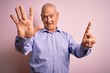 © Krakenimages.com - Middle age handsome hoary man wearing casual shirt standing over pink background showing and pointing up with fingers number six while smiling confident and happy.