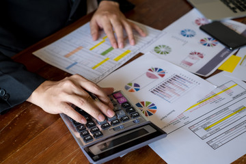 Businessman working with finance using calculator for create graph documents on meeting room office