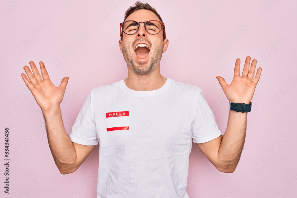 Stock-Foto „Handsome man with blue eyes wearing sticker with hello my ...