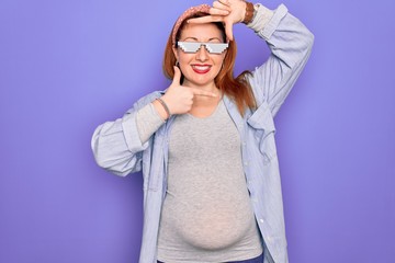 Sticker - Young redhead pregnant woman expecting baby wearing funny thug life sunglasses smiling making frame with hands and fingers with happy face. Creativity and photography concept.