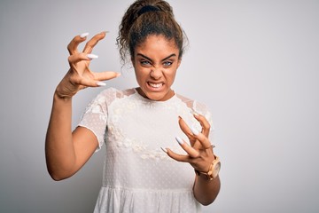 Sticker - Young beautiful african american girl wearing casual t-shirt standing over white background Shouting frustrated with rage, hands trying to strangle, yelling mad