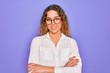© Krakenimages.com - Young beautiful woman with blue eyes wearing casual shirt and glasses over purple background happy face smiling with crossed arms looking at the camera. Positive person.