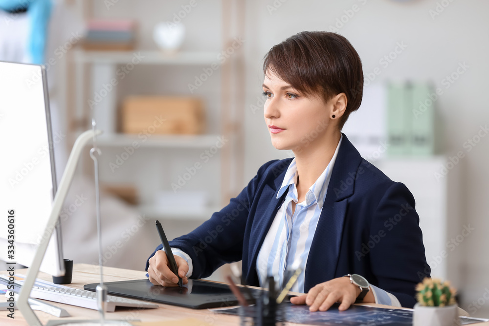 Young female designer working in office