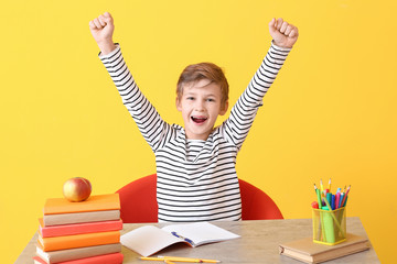 Wall Mural - Happy little boy with his homework done at table