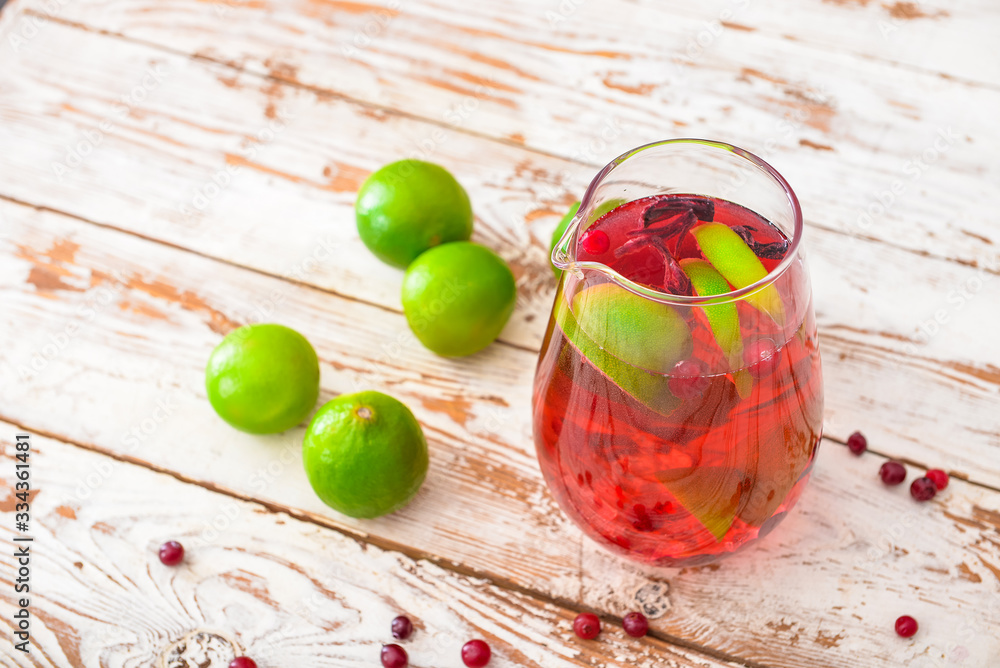 Jug of tasty cold tea on wooden table