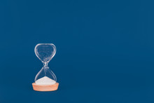 Hourglass With The Last Drops Of Sand. Concept Of Time And Timely Actions, Closing Opportunities. Place For Text