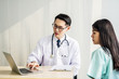 © TeTe Song - Doctor showing medical records on computer to his patient,he is pointing at the screen, Doctor explaining exam results in computer to patient at medical consultation, Medicine and health care concept.