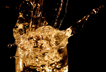 Wall Mural - Splashes and drops of water on a black background.