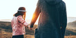 © Strelciuc - Caucasian couple walking hand in hand in a field during a sunny summer evening