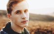 © Strelciuc - Close up portrait of ginger caucasian man posing in a field while looking at camera