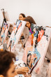 © Екатерина Рукосуева - Young women paint with brushes on easels in art class. art school, creativity and people concept