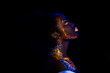 © Roman - unusual portrait of beautiful african fashion woman in neon UF light. attractive young model girl with fluorescent creative psychedelic make-up, body-art