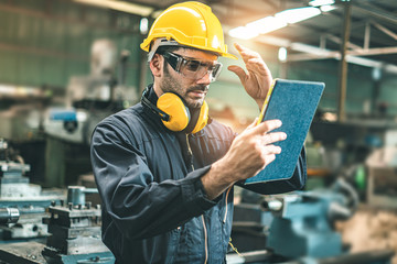 Industrial Engineers in Hard Hats.Work at the Heavy Industry Manufacturing Factory.industrial worker indoors in factory. man working in an industrial factory.Safety first concept.