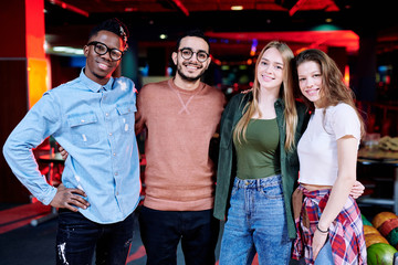 Sticker - Group of young cheerful intercultural friends standing in bowling room