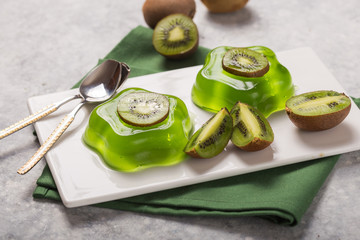 Wall Mural - Delicious fresh two green jelly with kiwi slices on concrete table