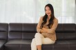 © siraphol - Portrait beautiful young asian woman happy smile relax on sofa in living room