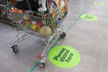 Social Distancing Marks On Supermarket Floor Intended To Stop Or Slow Down The Spread Of A Contagious Coronavirus (COVID-19)  Disease.