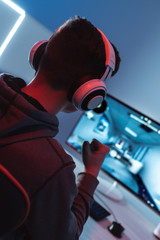 Wall Mural - The gamer playing video game on his personal computer