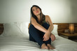 © TheVisualsYouNeed - indoors bed portrait of young desperate and depressed Asian Chinese woman feeling scared and overwhelmed crying alone during covid-19 virus home lockdown and quarantine