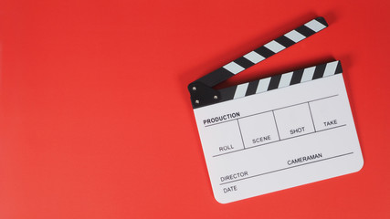 clapperboard or movie slate. it use in video production ,film, cinema industry on red background.