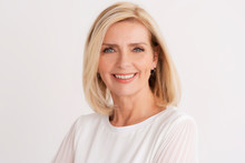 Headshot Of Blond Senior Woman While Standing At Isolated White Background