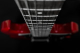 Fototapeta Tęcza - Red electric guitar closeup  on black background