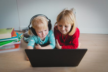 Cute Girls With Headphones Doing Educational Games On Computer, Online Learning