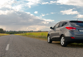 UKRAINE-OCTOBER 1, 2017: Close up side of SUV Hyundai ix35 on the asphalt road. Car on the road. Automotive photography. Space for text. Nature background with car. Landscape with auto.