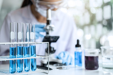 biochemistry laboratory research, chemist is analyzing sample in laboratory with microscope equipmen