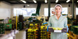 © JackF - Young woman in uniform during sorting at warehouse at apples factory