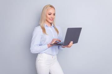 Wall Mural - Photo of positive cheerful confident smart girl use laptop read company development information have online communication wear good look trousers isolated over gray color background