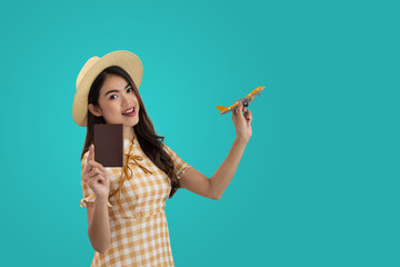 Young Asian woman tourist with passport isolated on blue studio background