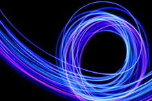 Light Painting Photography, Long Exposure Photo Of Purple And Blue Streaks Of Vibrant Color Against A Black Background