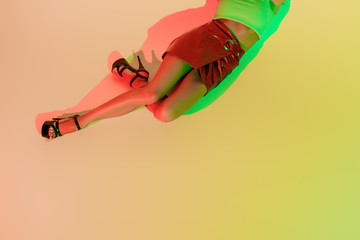 Wall Mural - cropped view of stylish girl lying on yellow background with green and red shadows